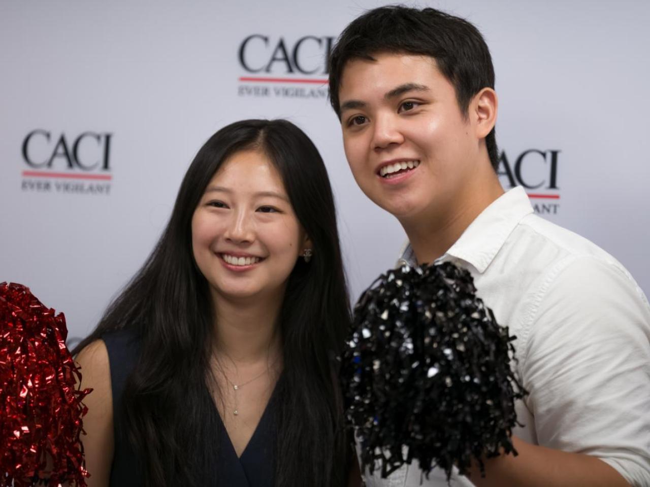 Two people at CACI's National Intern Day celebration