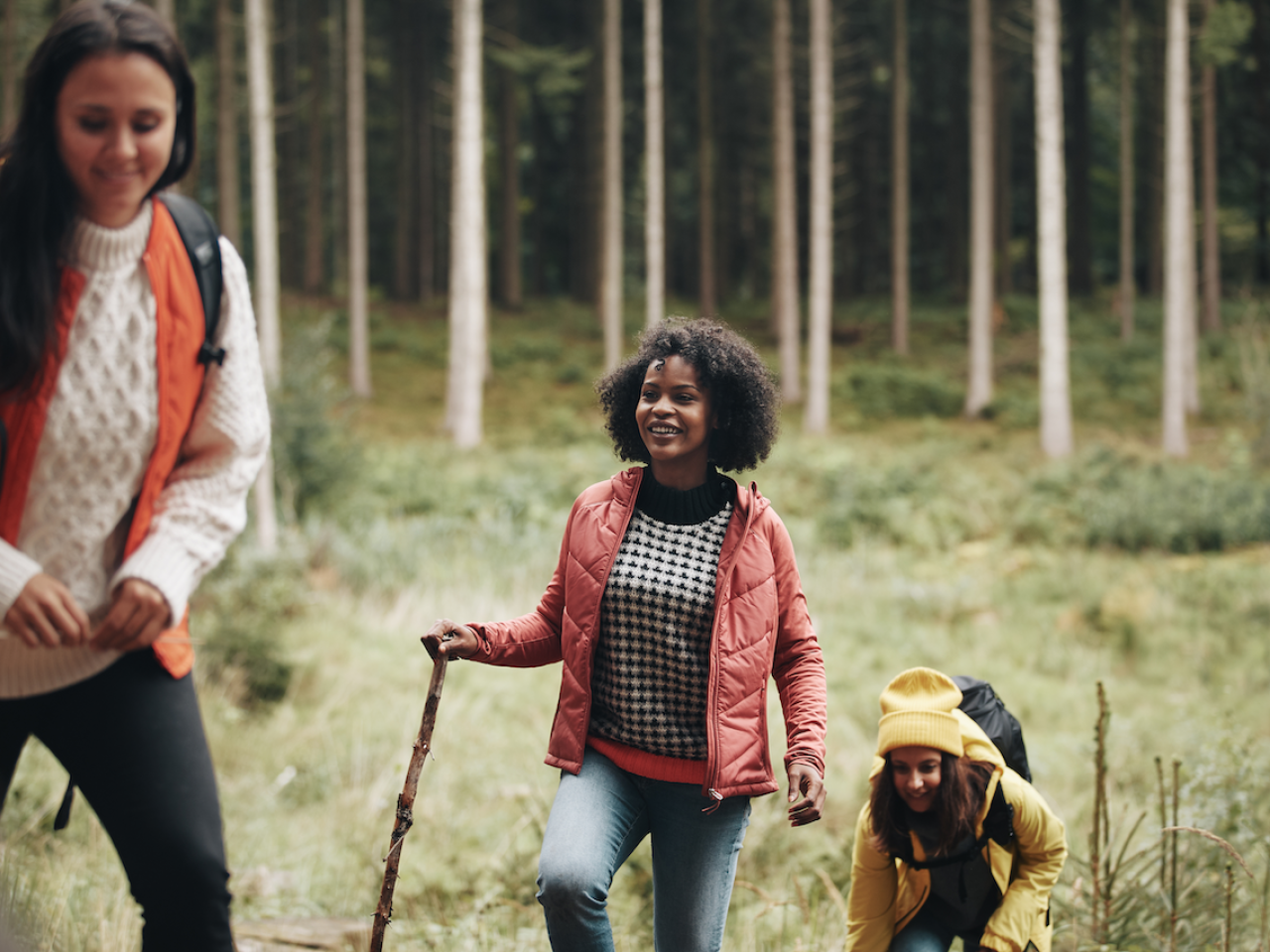 Woman and girls walking through forest