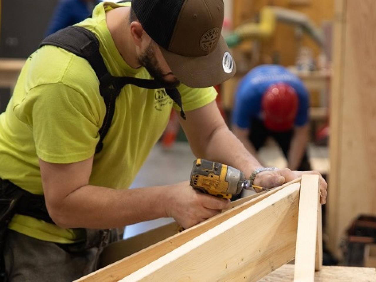 A person joining wood pieces in a workshop.