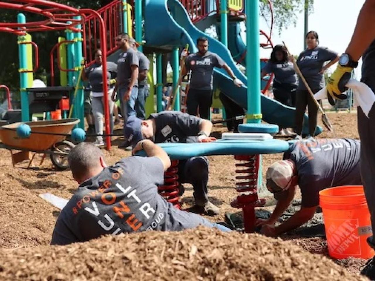 Volunteers shown assembling the playground.