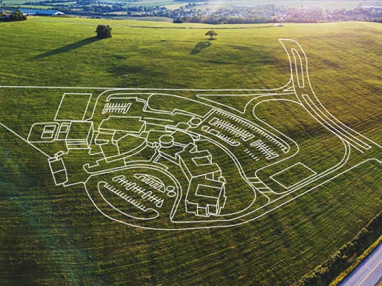 2D drawing of a Tetra Tech master plan for a wastewater treatment overlaying an aerial photo of a field.