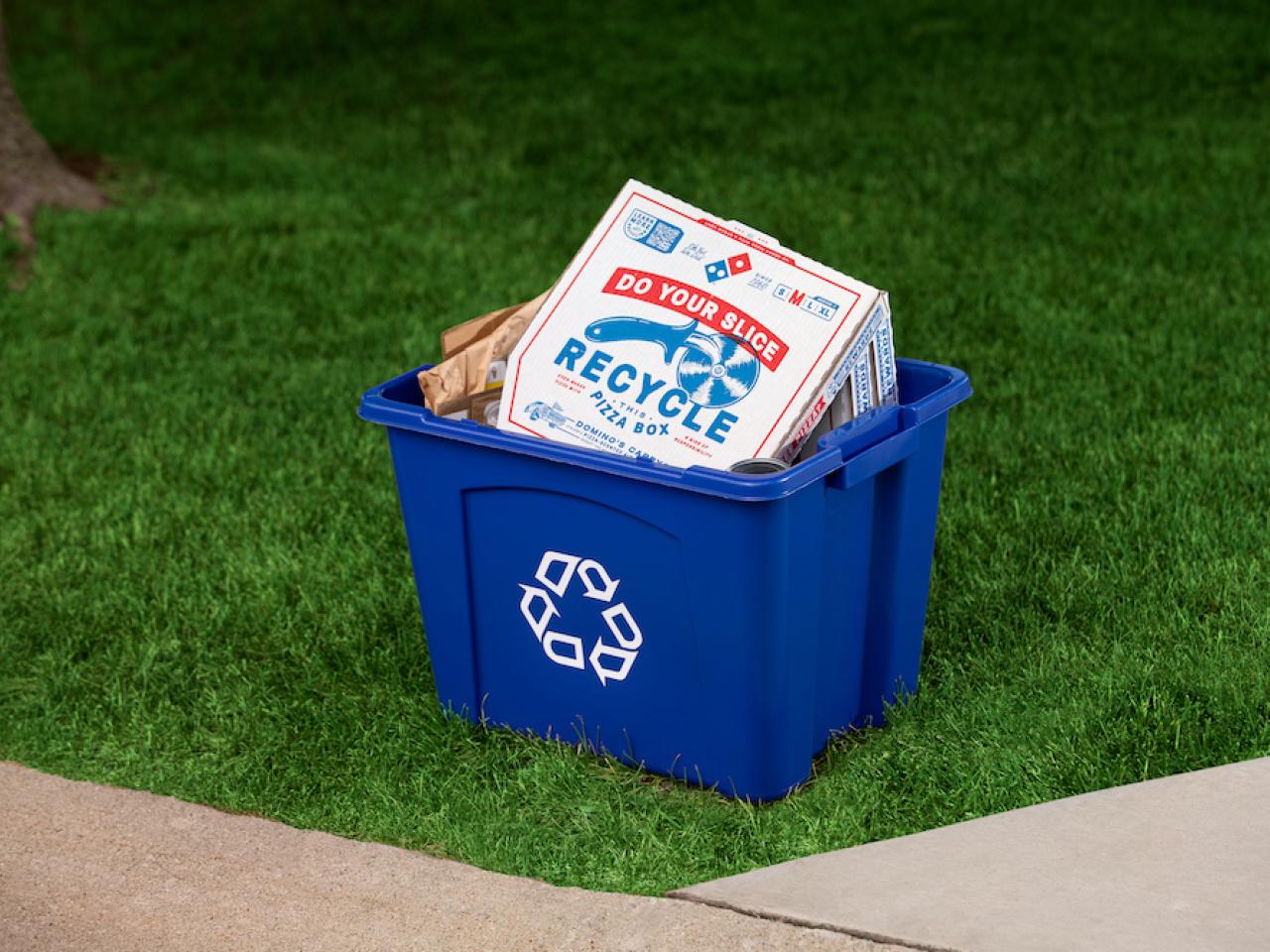 A pizza box inside a recycling container 