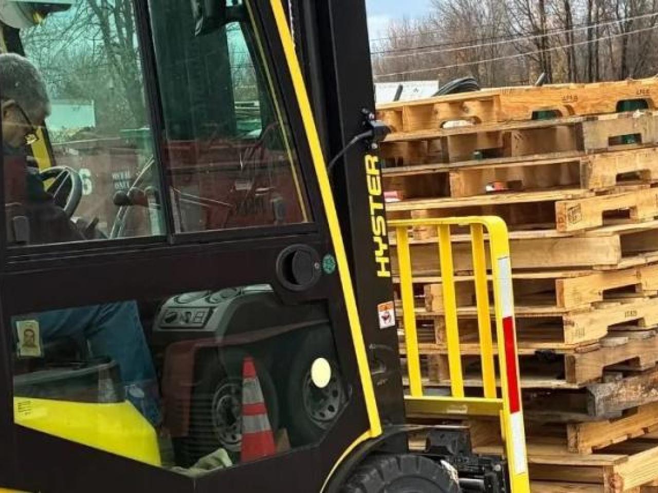 Forklift moving wooden pallets
