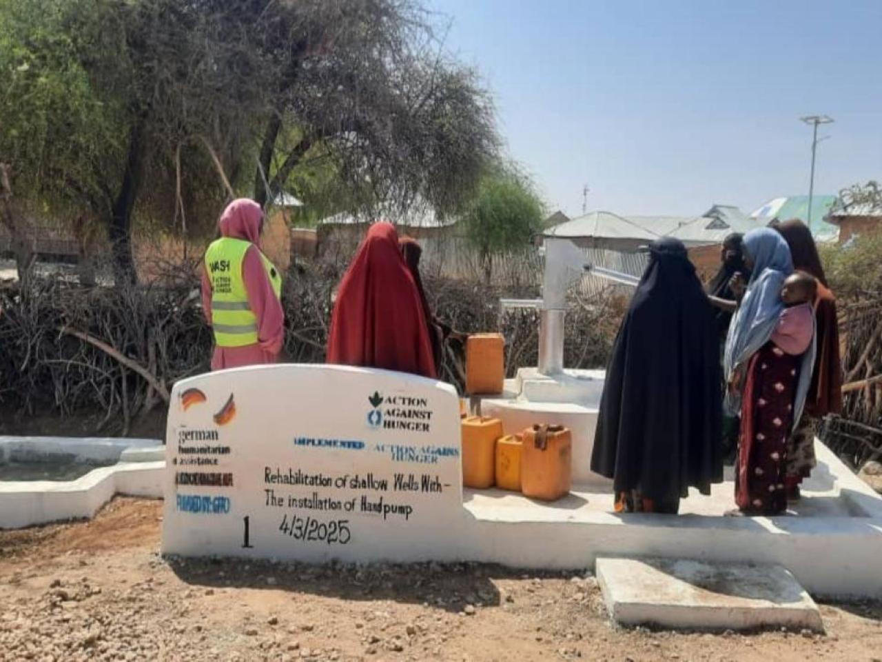 Women gather at the rehabilitated well in Wajid. 