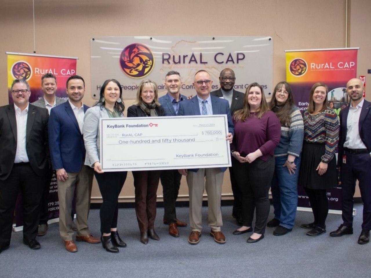 RurAl Cap and KeyBank representatives shown with a $150,000 grant check.