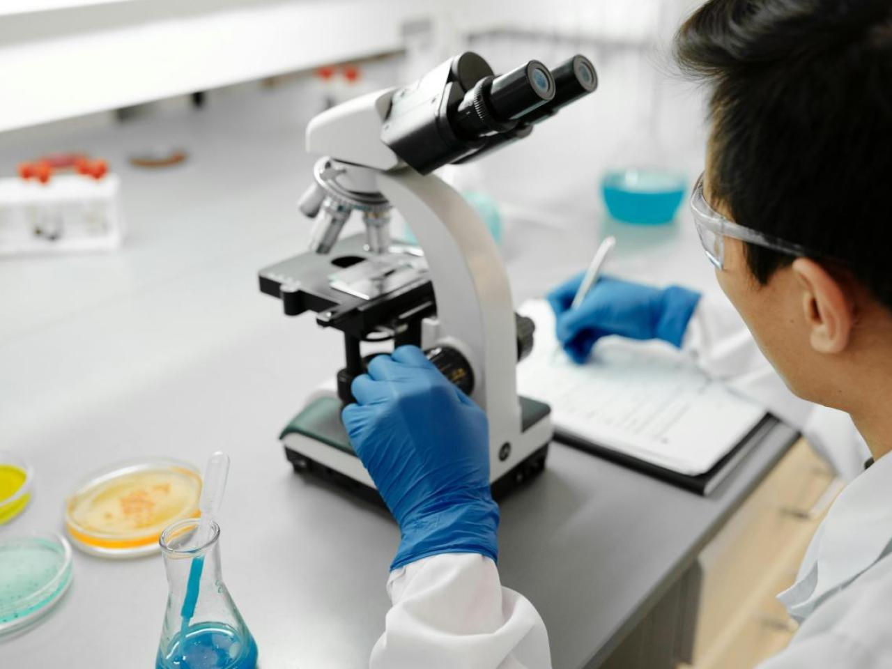 Scientist using microscope in laboratory