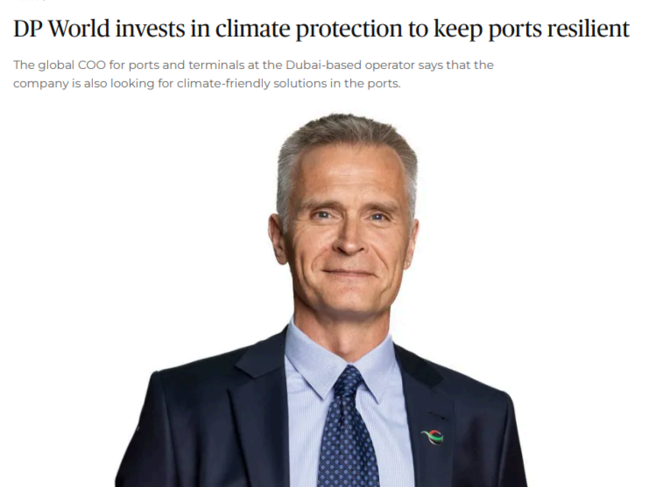 Portrait of Tiemen Meester, DP World's Global COO for Ports & Terminals, wearing a navy suit and blue tie, as featured in a ShippingWatch article about the company’s investments in climate protection and port resilience.