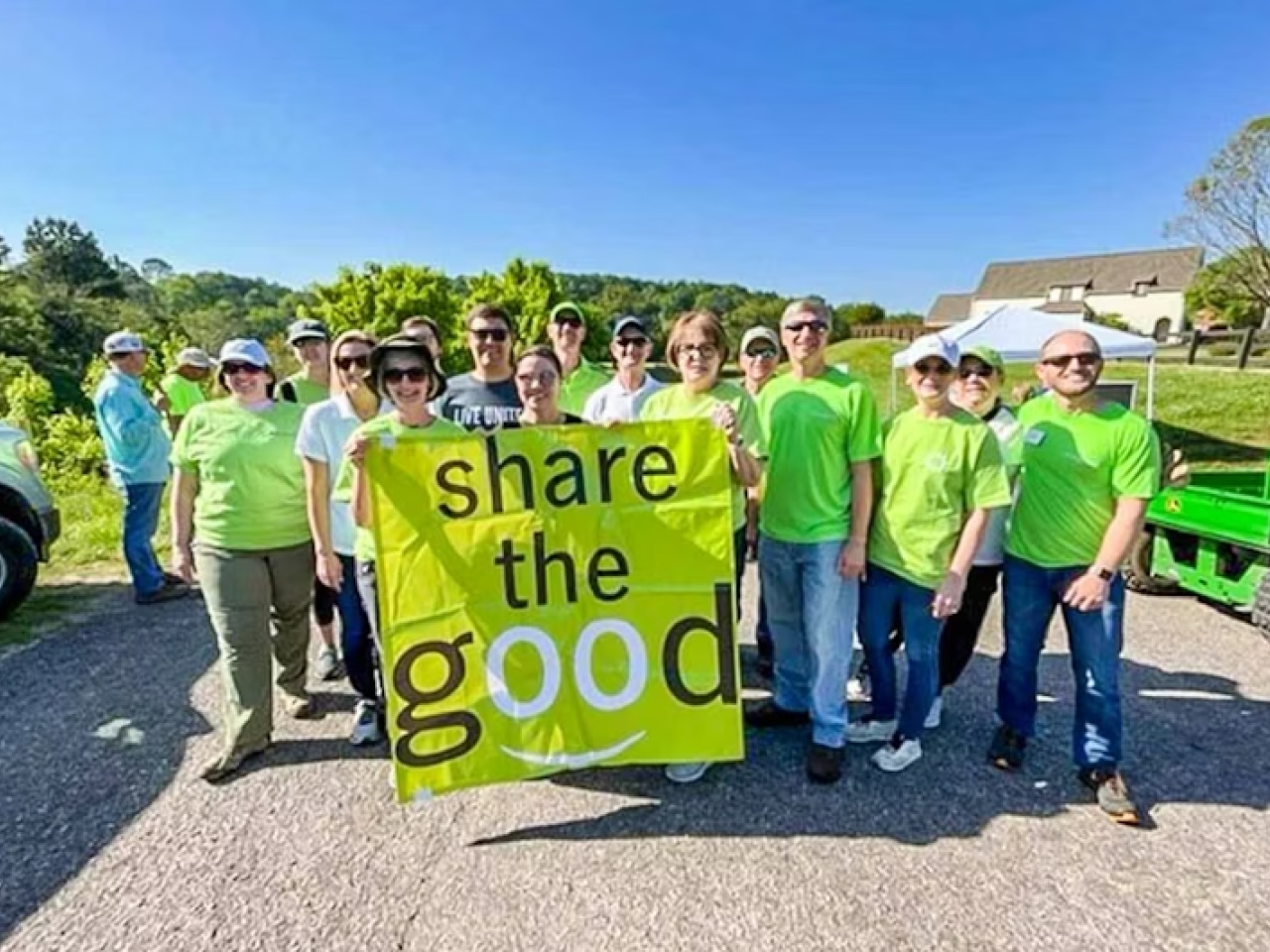 Volunteers with a share the good banner
