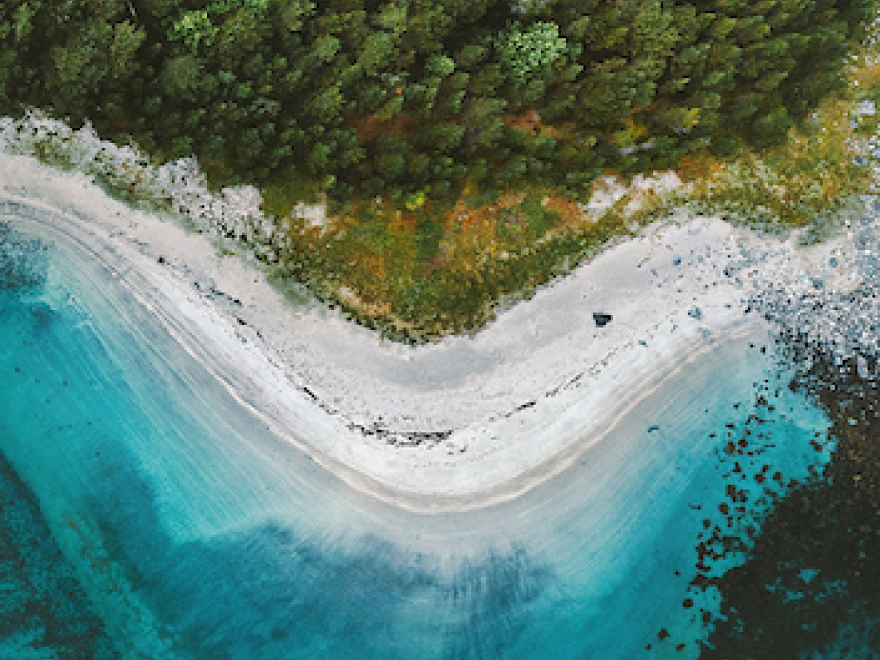 Blue waves crashing into a beach.
