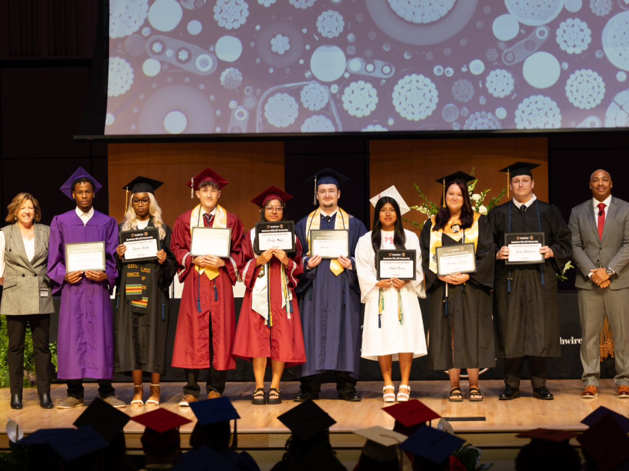 12 for Life students at graduation holding certificates