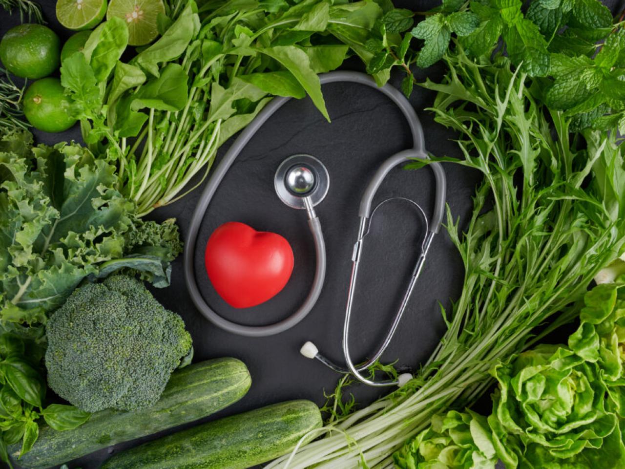 A stethoscope and a small heart are shown with produce.