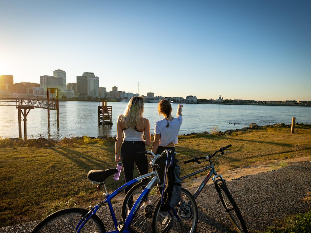 Two people looking at cityscape with bikes next to them