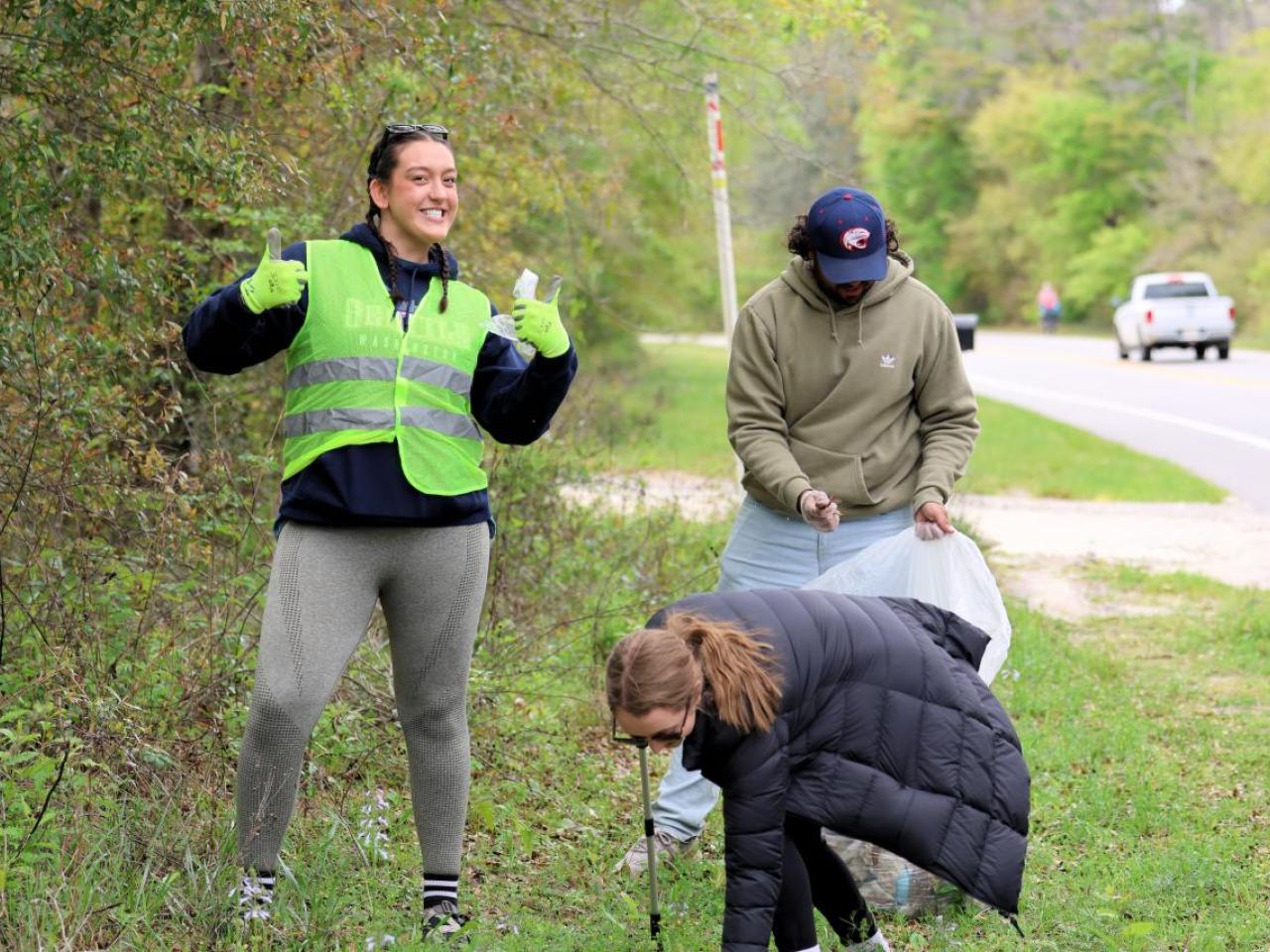 AEG employees and fans participate in the coastal clean-up initiative at Fort Morgan.
