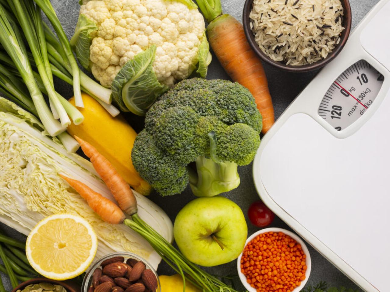 Vegetables and fruits shown near a scale.