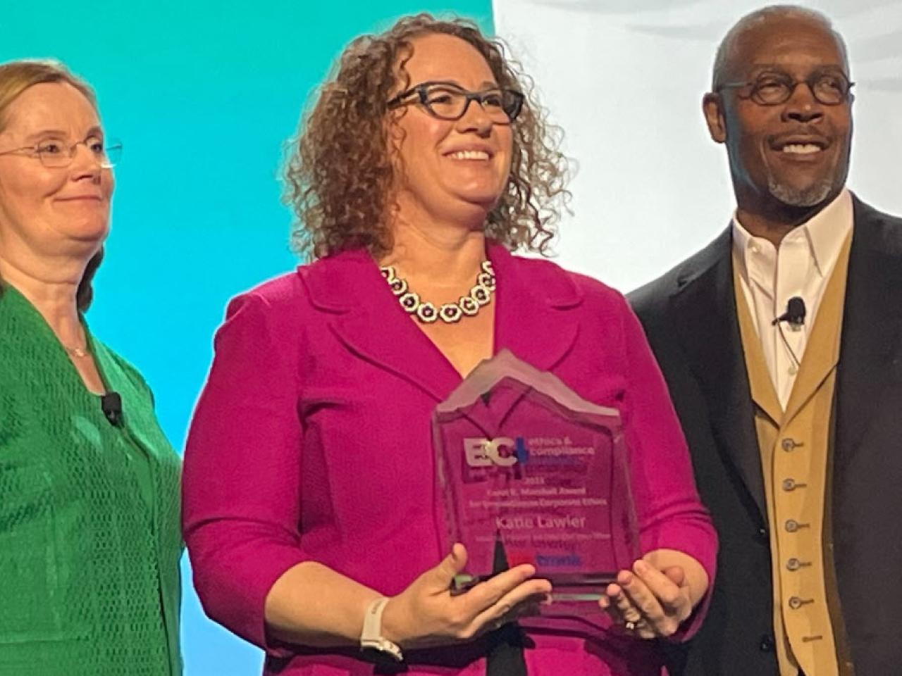 Katie Lawler, center, was recently recognized by Ethics & Compliance Initiative with its Carol R. Marshall Award for Innovation in Corporate Ethics.