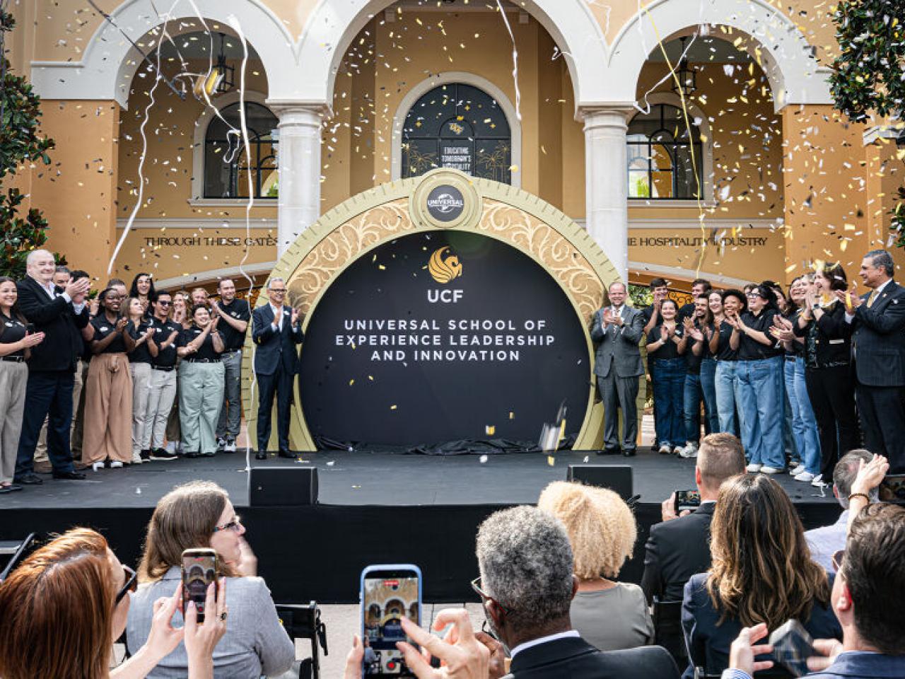 Group photo with confetti in front of Universal School of Experience Leadership and Innovation
