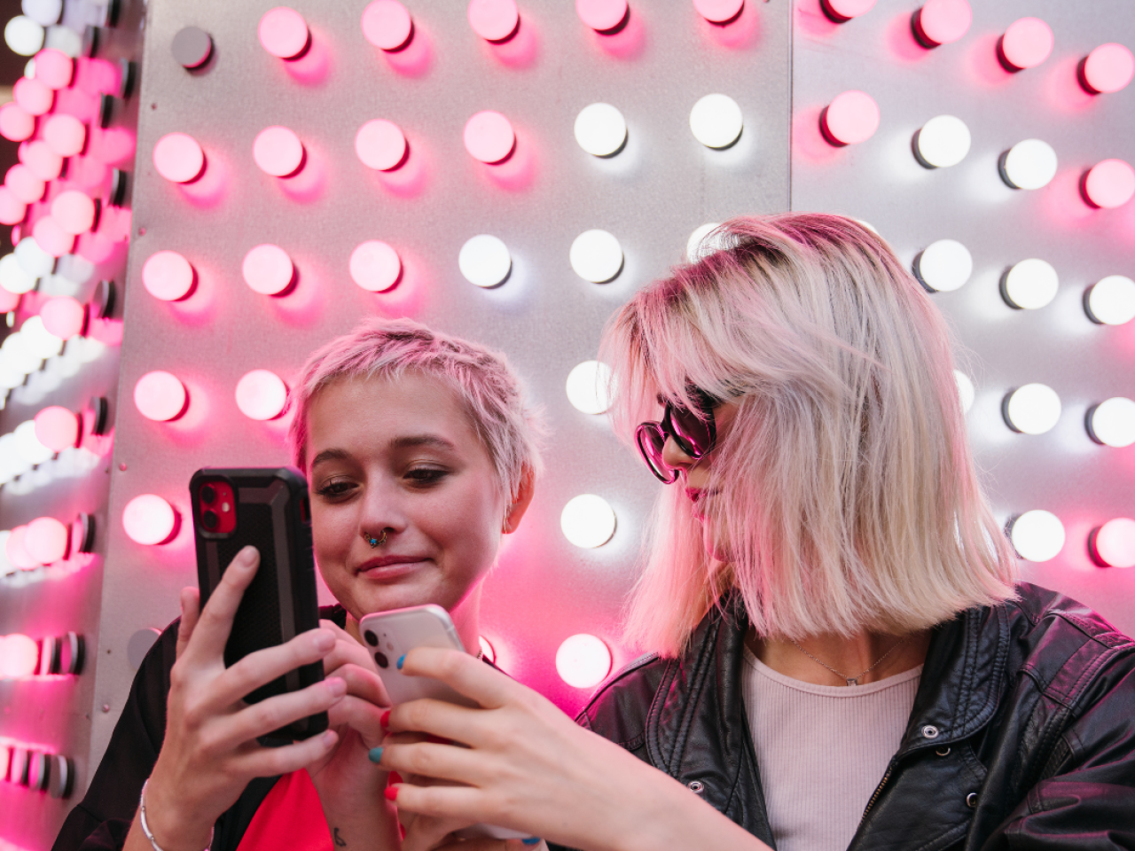 Two young women looking at cell phones