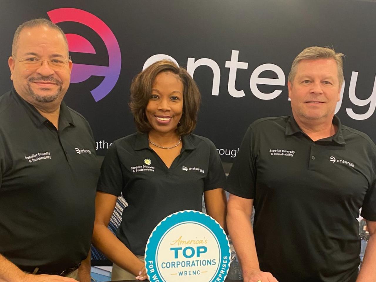 From left, Rivers Frederick, Kya Moller and Dan Boren stood in front of the entergy logo at the WBENC conference