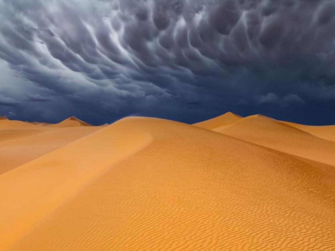 Illustration of a storm over a desert.