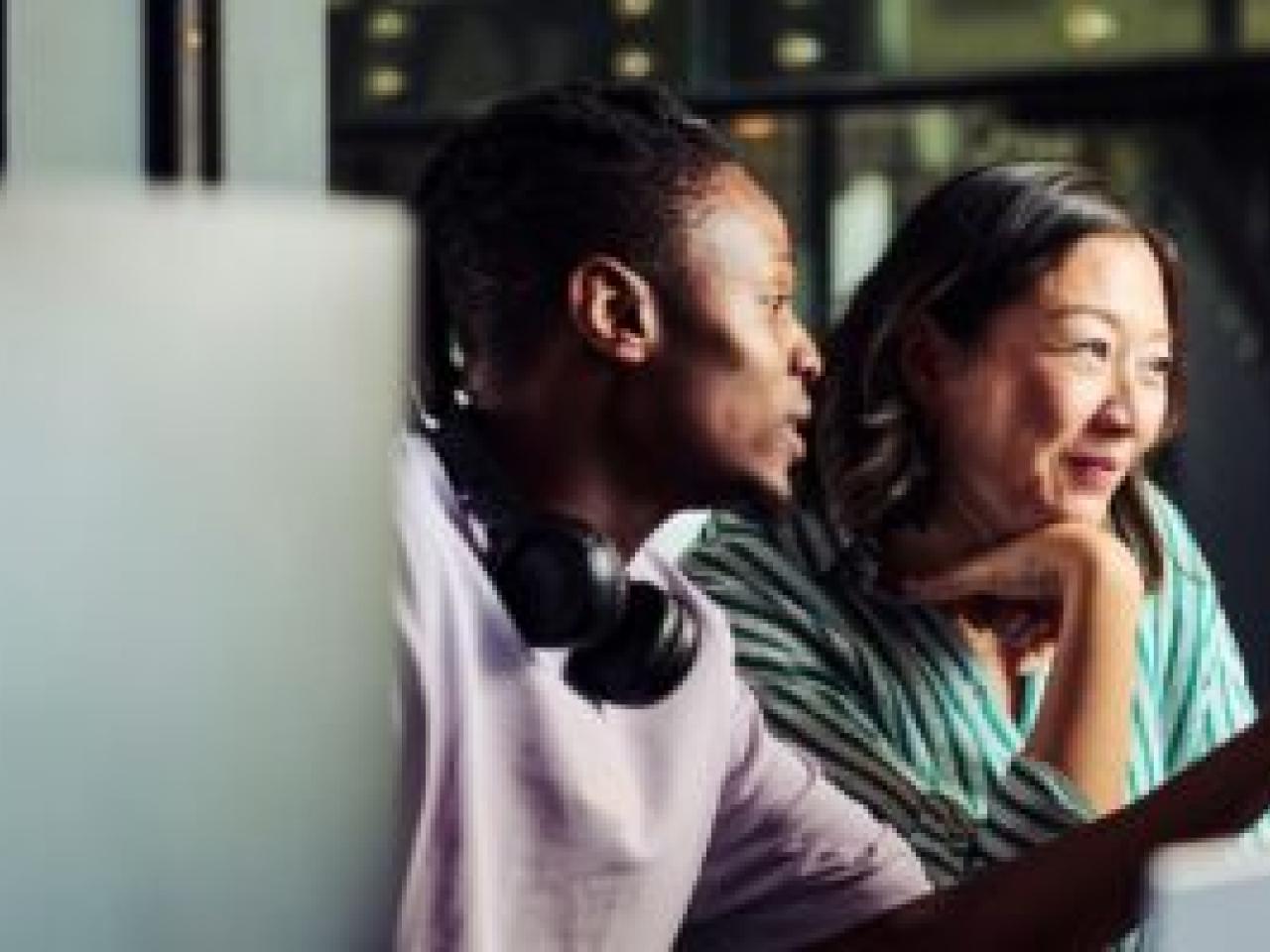 two people looking at a computer