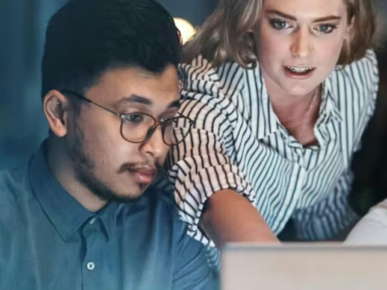 Three people looking at a laptop screen