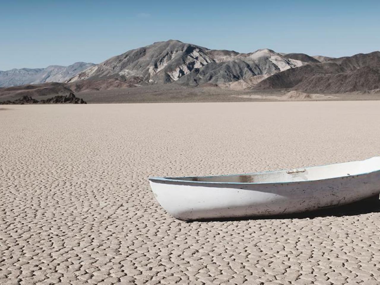 A small boat in a barren desert landscape.