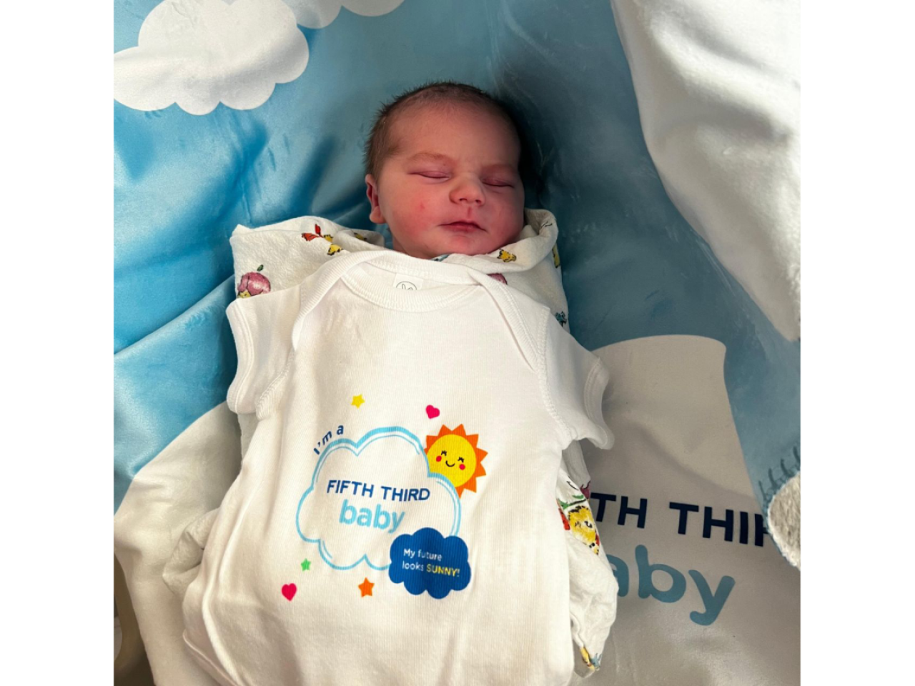 baby in an "I'm a Fifth Third Baby" onsie
