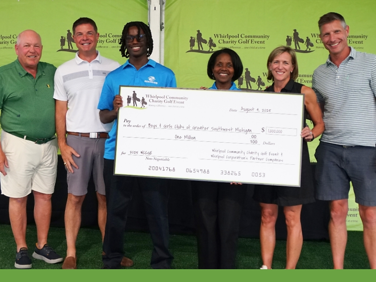 People posing with an oversized check