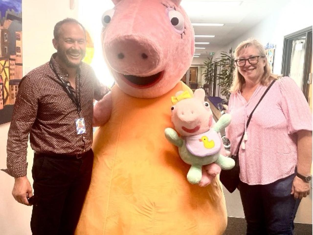 people posing with mascot