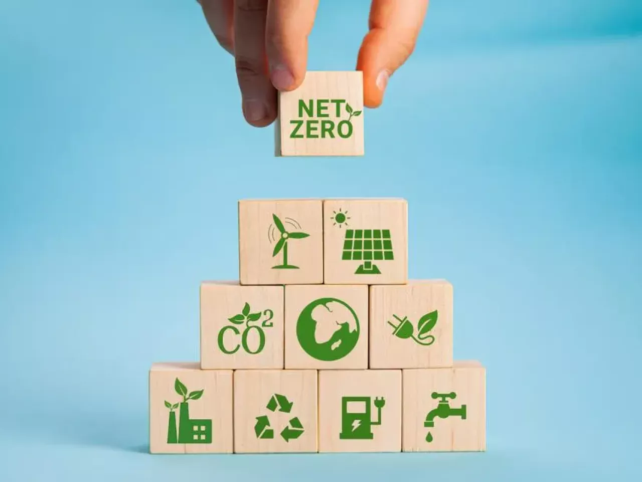 person adding "net-zero" block on top of other blocks