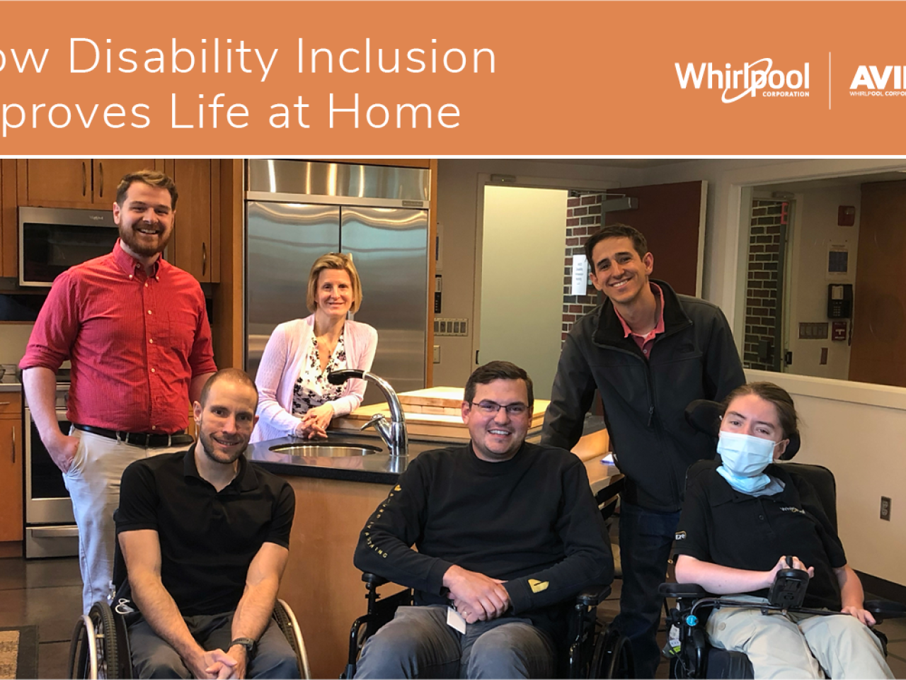 3 people stand behind 3 people in wheelchairs in a home kitchen