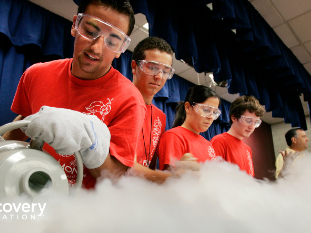 Students in safety glasses working on a project
