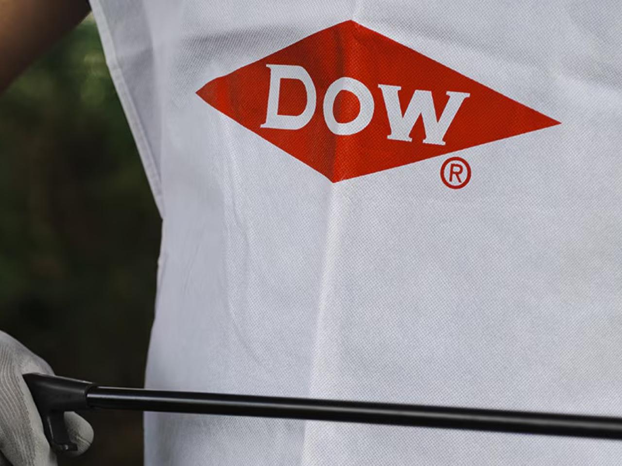 person wearing gloves and a Dow shirt