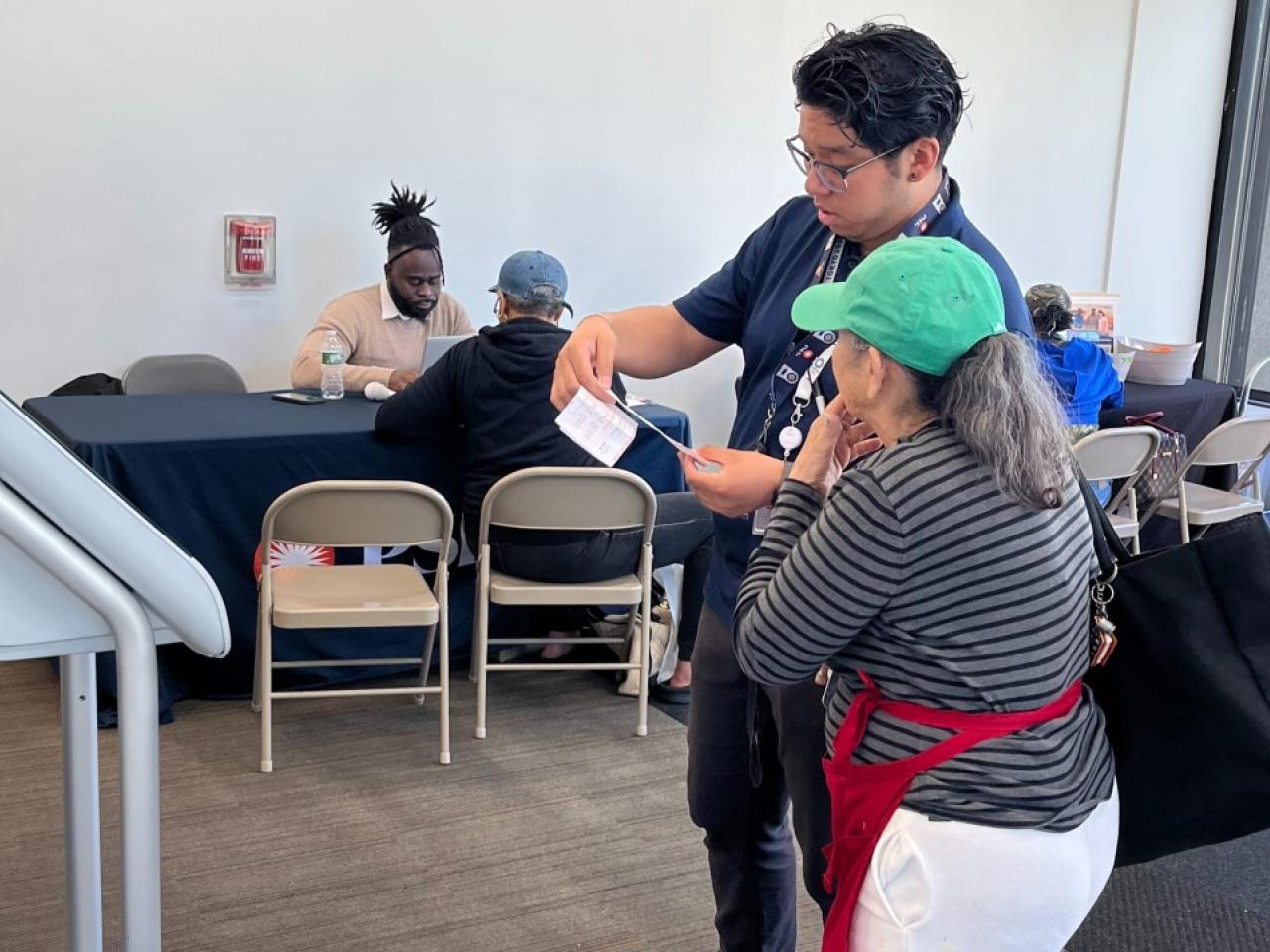 Two people examining a piece of paper