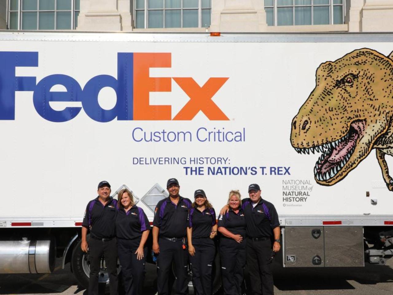people in front of FedEx truck