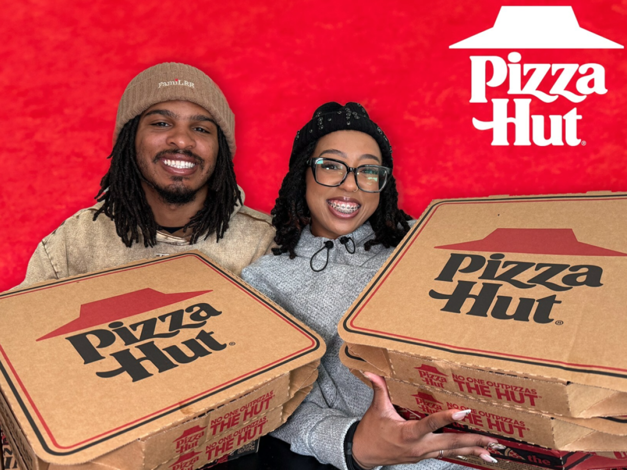 Keith Lee and his wife holding pizza hut boxes