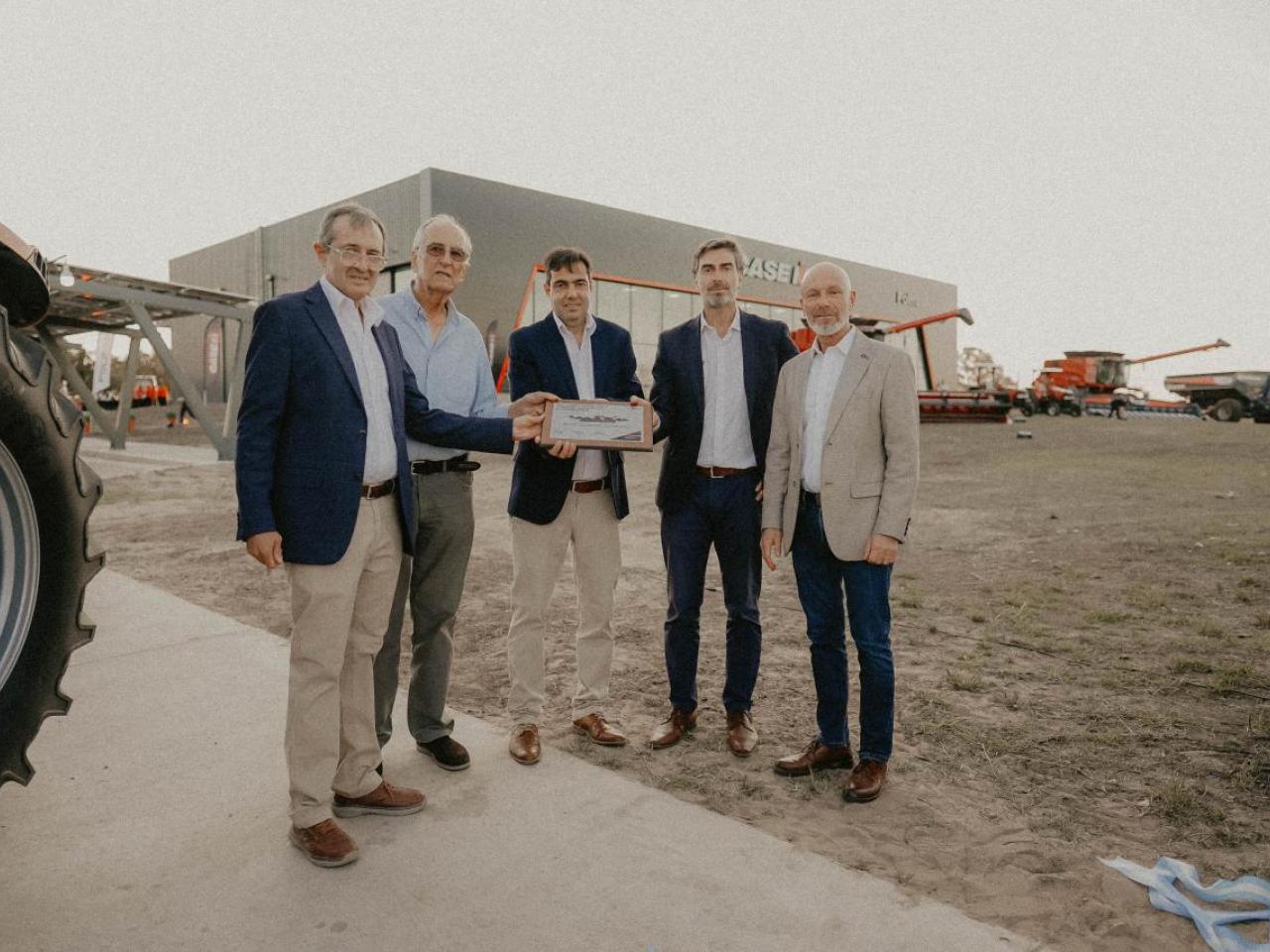 Five people standing together outside a dealership