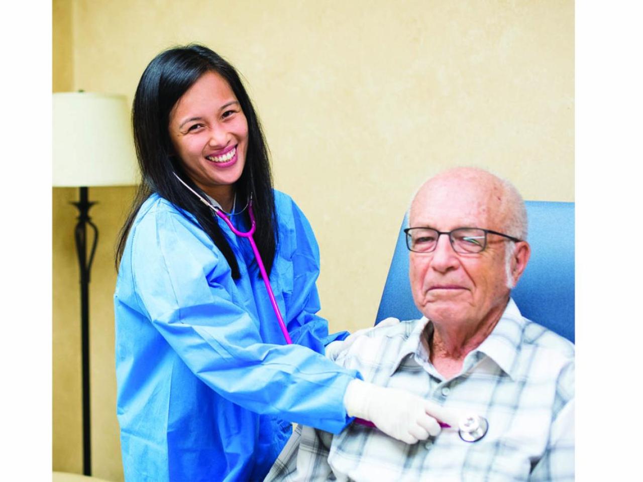 healthcare worker listening to a patient's heart with a stethoscope