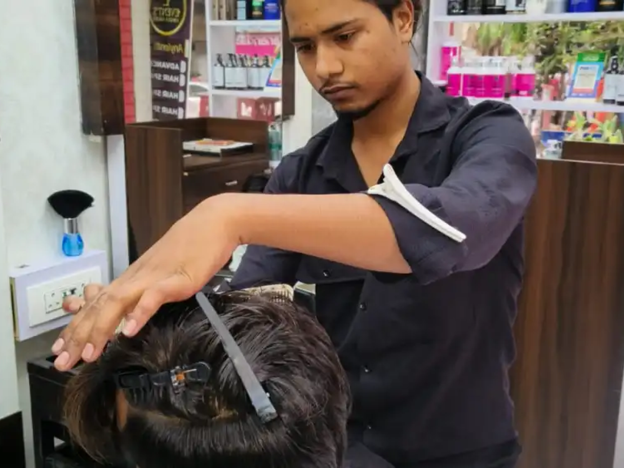 A hairstylist working on a client's hair