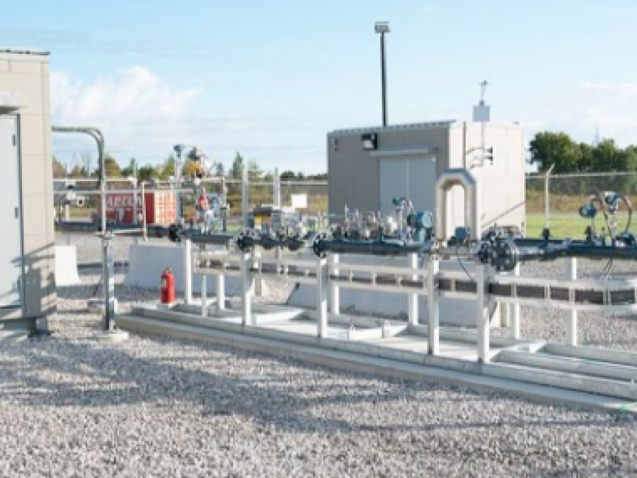 exterior energy building with industrial piping and gravel ground covering