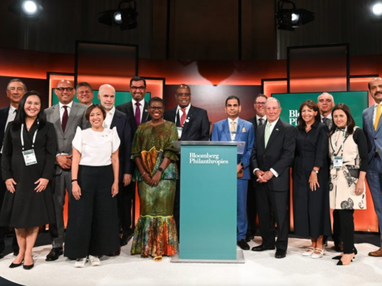 group photo in front of the Bloomberg Philanthropy lectern