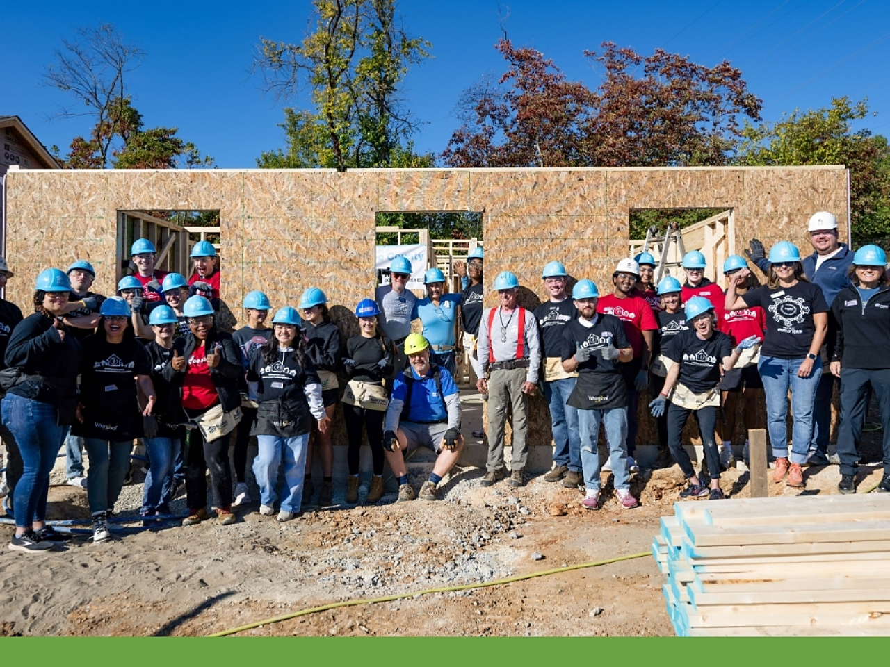 Whirlpool Corporation, Habitat for Humanity of Monroe County, and Indiana University’s Kelley School of Business are marking a major milestone in their long-standing collaboration: 15 years of building hope and homes together in Bloomington, Ind. This year’s build constructed five new net-zero homes in Bloomington’s Osage Place neighborhood as part of the BuildBetter with Whirlpool program, emphasizing the company’s deep commitment to sustainable housing and community building. A group of volunteers outside a home being built