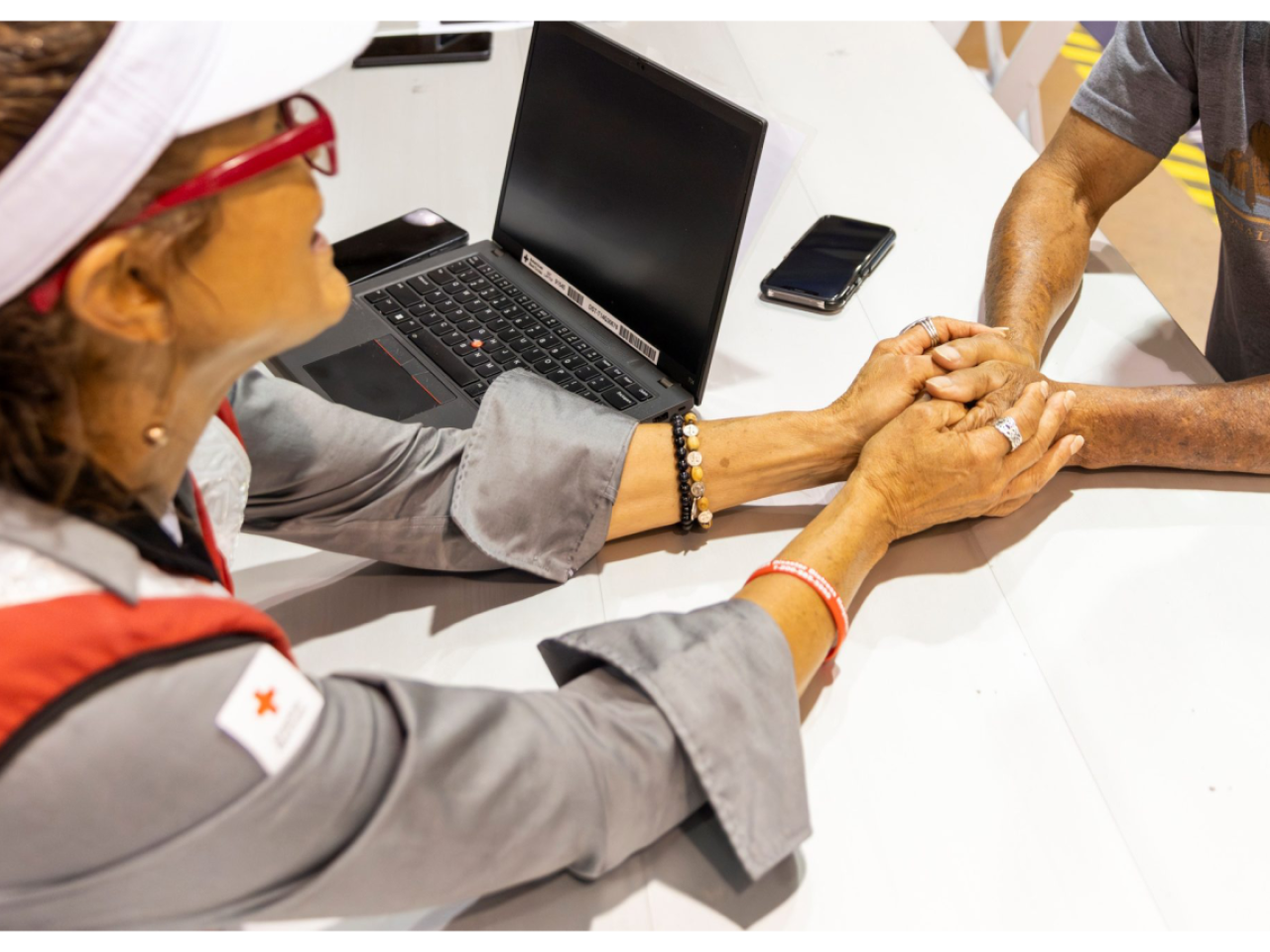 Red Cross volunteer holding someone's hands