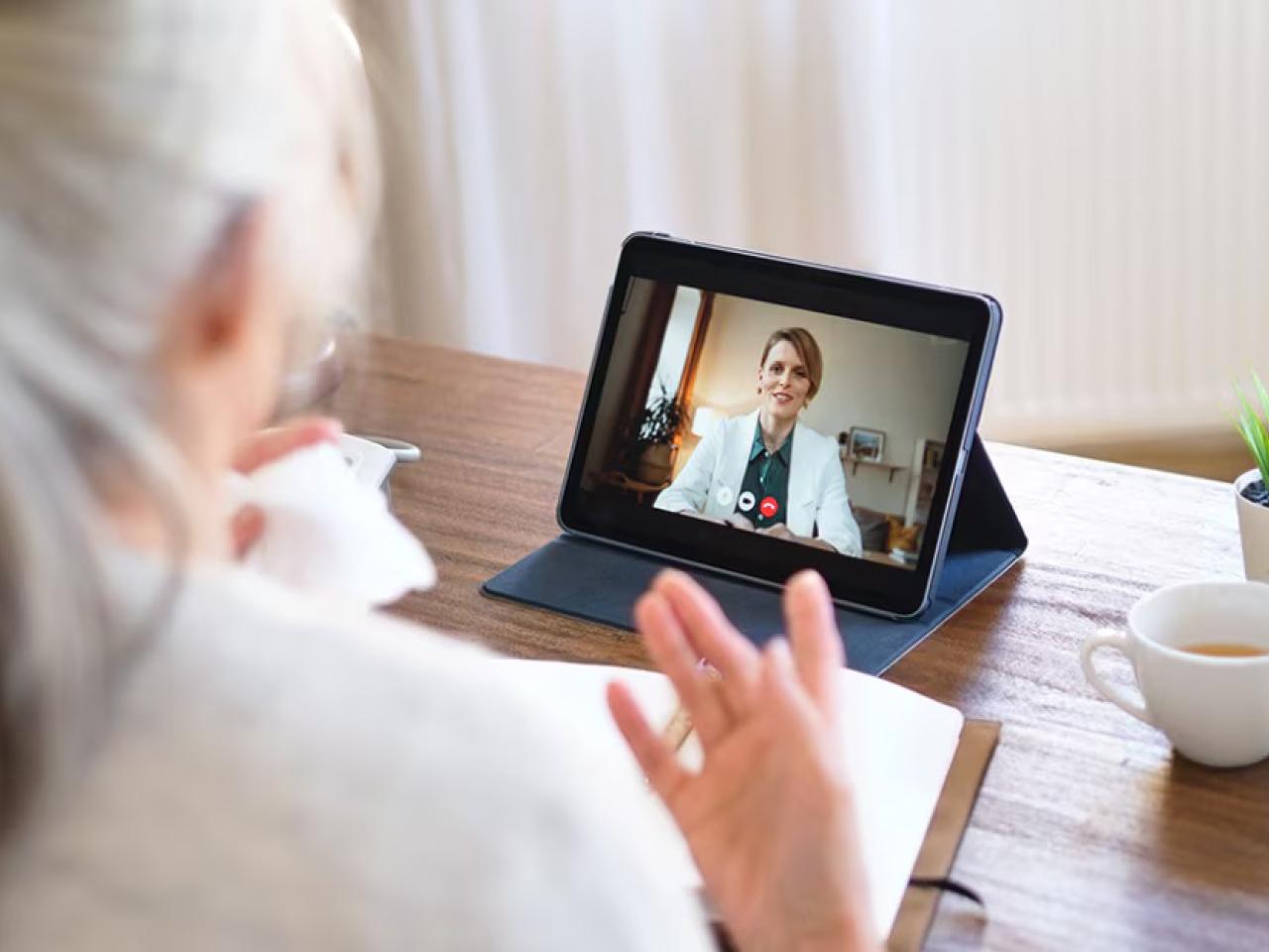 A person having a video call on a tablet device 