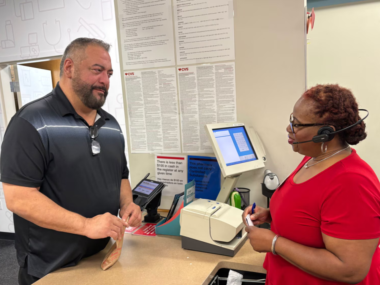 A patient speaking with someone over a counter