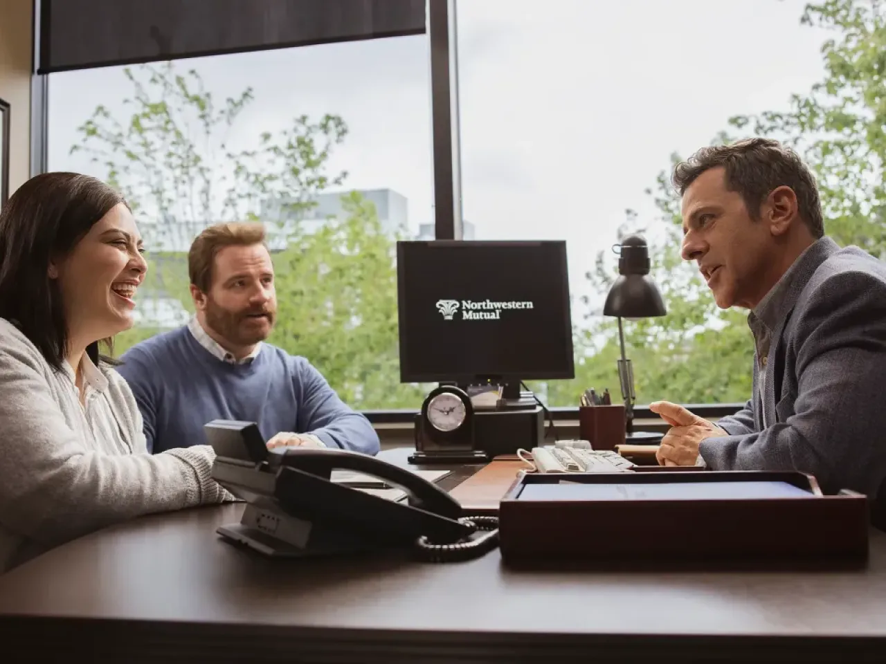 an advisor speaking with two clients