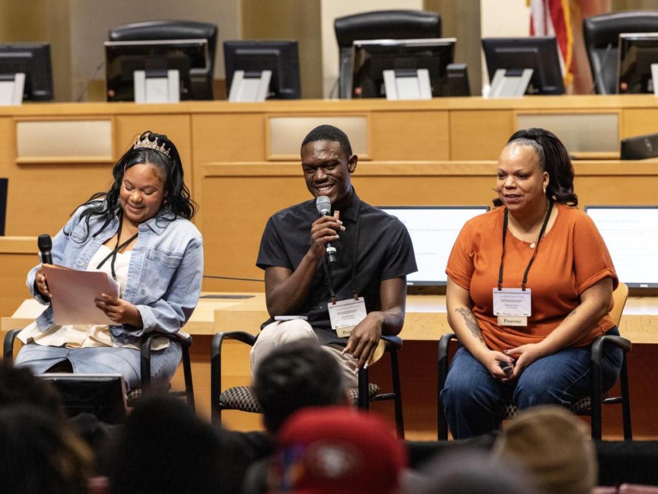 Three people presenting to a group