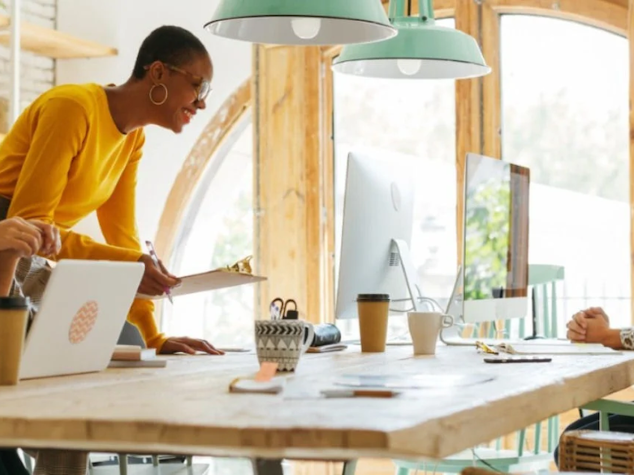 Catalina Banuleasa at a table with three co-workers.