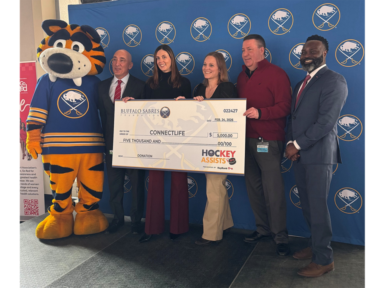 People standing with an oversized check