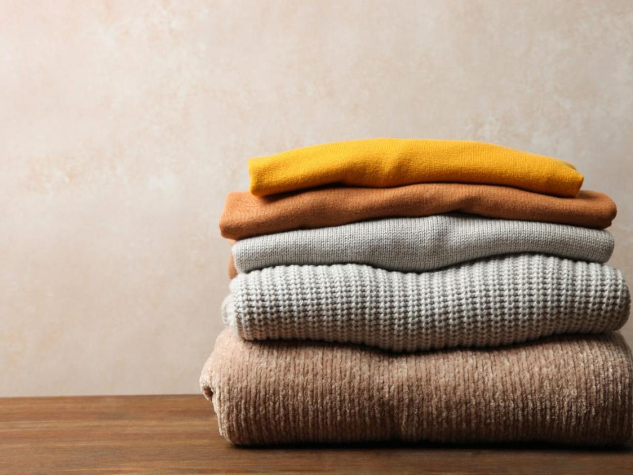 folded sweaters on a table